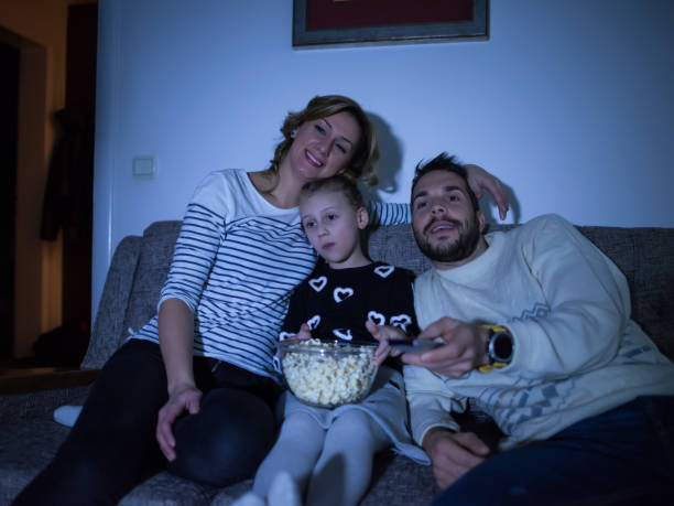 istock Family watching TV at home 910634234