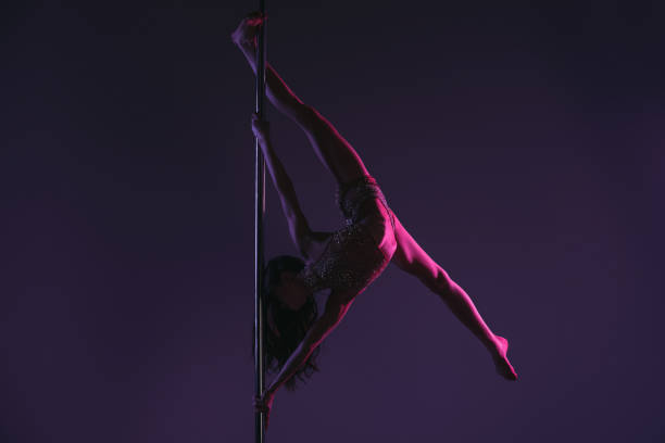 istock woman exercising with pole on blue 910635246