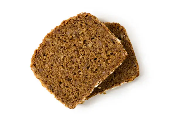 Bread whole grain two slices stacked over one another isolated on white background, top view, closeup
