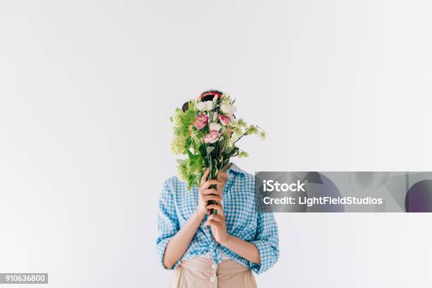 Woman Covering Face With Flowers Stock Photo - Download Image Now - Flower, Holding, Obscured Face
