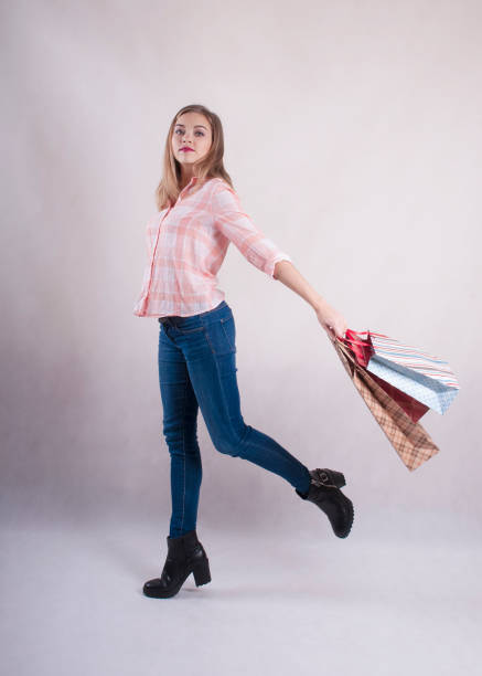 istock Girl with bags in jeans studio 910637016