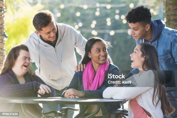 Five Teenage Friends Talking One With Down Syndrome Stock Photo - Download Image Now
