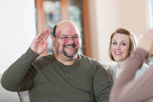 istock Man with family, using sign language to say HELLO 910640418