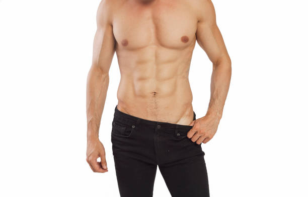 黒の背景に彼の筋肉を示す若い男 - men muscular build abdominal muscle large ストックフォトと画像