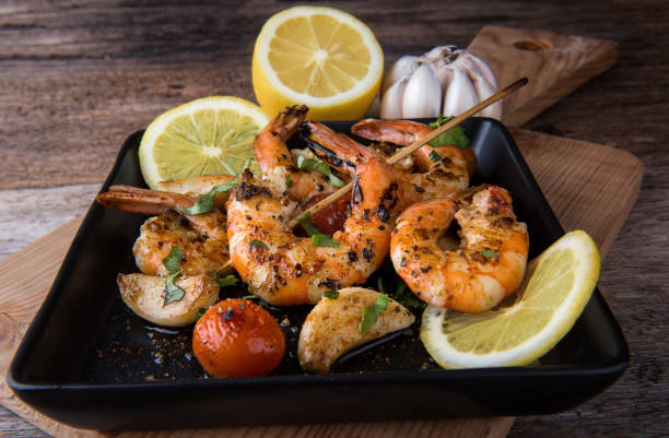 istock Skewers Barbeque grilled prawns with spicy ingredients. 910643200