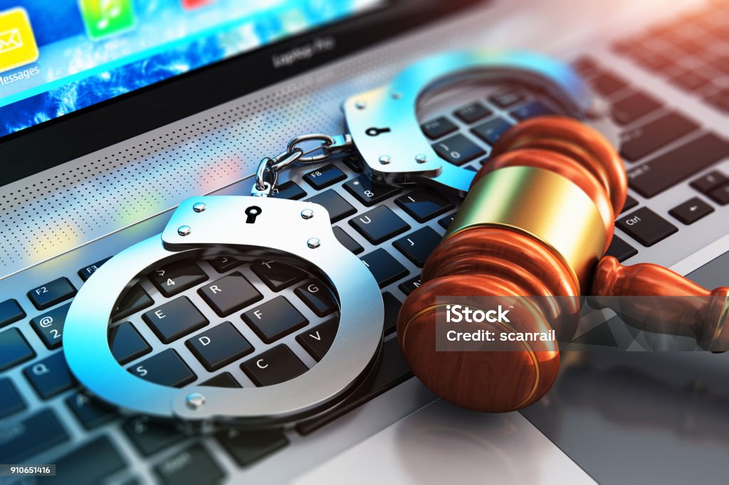 Handcuffs and judge mallet on laptop keyboard Creative abstract cyber crime, online piracy and internet web hacking concept: 3D render illustration of the macro view of metal handcuffs and wooden judge mallet, gavel or hammer on laptop notebook computer keyboard with selective focus effect Crime Stock Photo