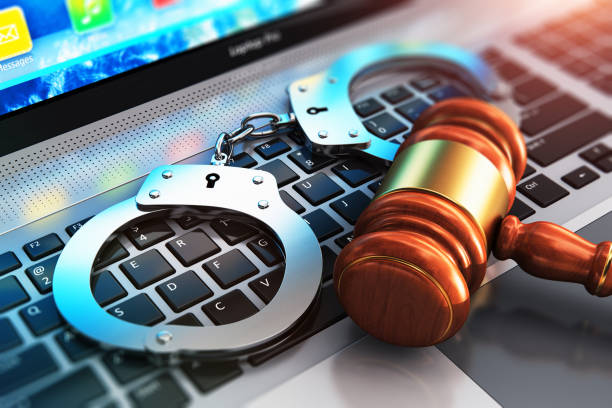 Handcuffs and judge mallet on laptop keyboard Creative abstract cyber crime, online piracy and internet web hacking concept: 3D render illustration of the macro view of metal handcuffs and wooden judge mallet, gavel or hammer on laptop notebook computer keyboard with selective focus effect pirate criminal stock pictures, royalty-free photos & images