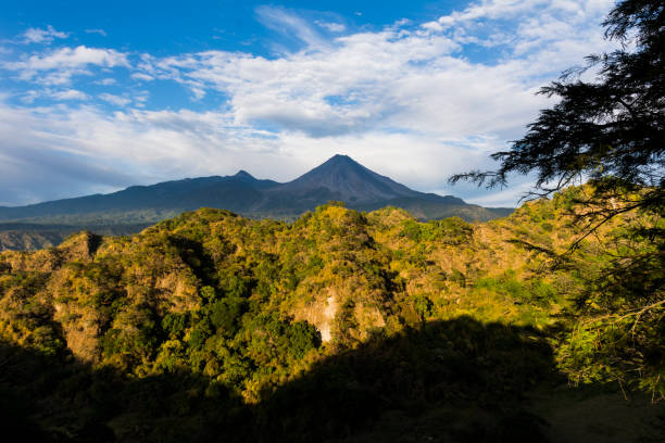 istock Green hills and volcano. 910651572