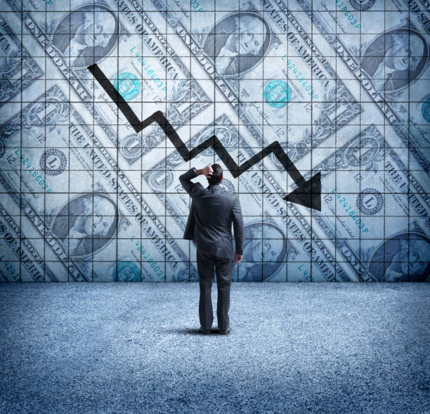 istock Businessman Looking Up At a Chart That Indicates A Falling U.S. Dollar 910651852