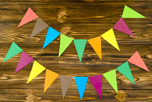 istock paper  flags  party garland  on wooden background 910655132