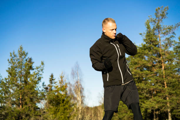 istock Male caucasian middle age boxer training outside in nature 910655524