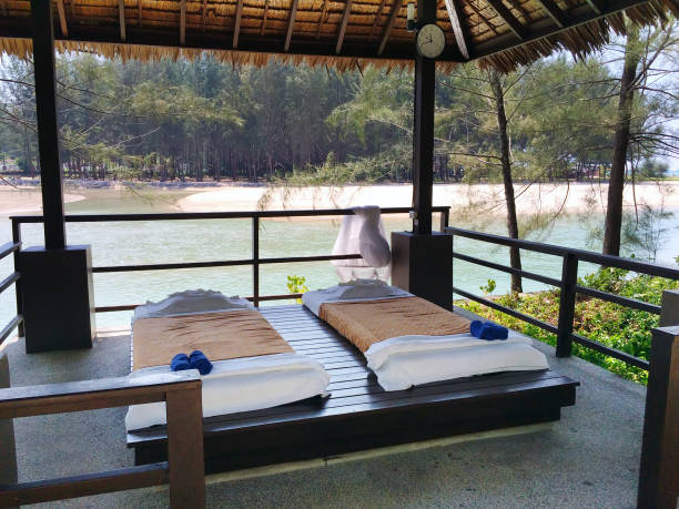 istock The massage pavilion with beds for rest on the sandy beach. Thailand 910656306