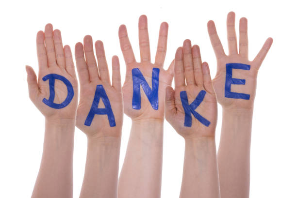 istock Letters On Hands Building Danke Means Thank You 910659042