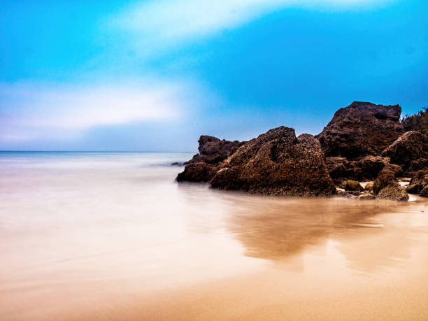 istock Long exposure ocean swirling around rocks, Tarifa, Spain 910663276