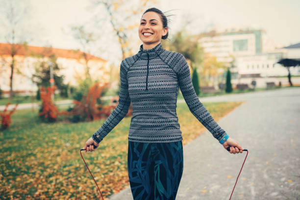 Sportswoman jumping rope in the park.