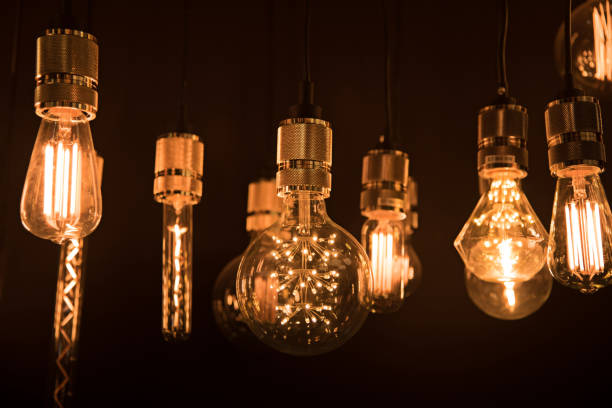 istock Illuminated Lighting Equipment Hanging In Darkroom 910682624