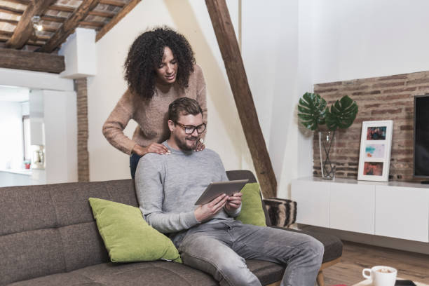 istock Multi ethnic couple looking tablet at home 910695006
