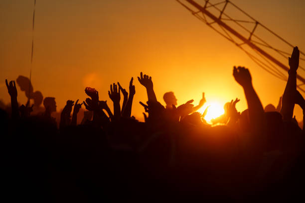 istock People silhouettes with raised up a human hands 910707274