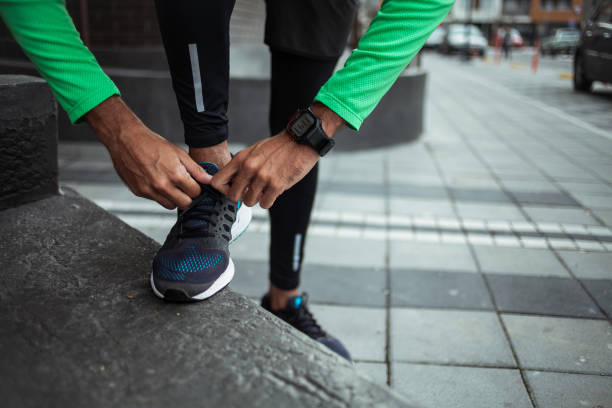 istock Male jogger tying his shoe 910707488