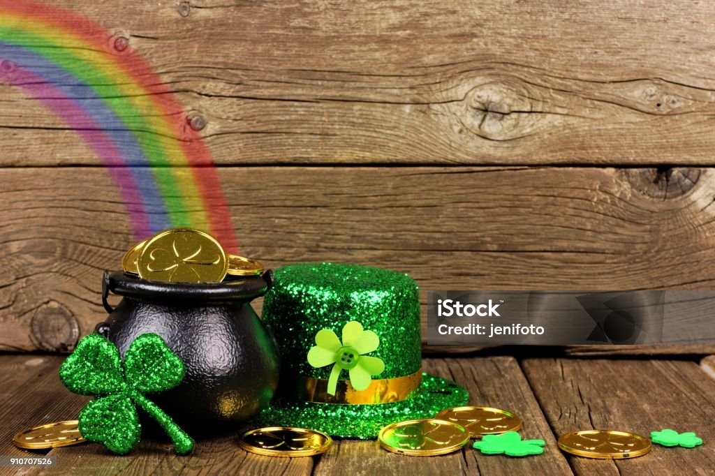 St Patricks Day Pot of Gold with rainbow & decor against wood St Patricks Day Pot of Gold with rainbow, shamrocks and hat against rustic wood St. Patrick's Day Stock Photo