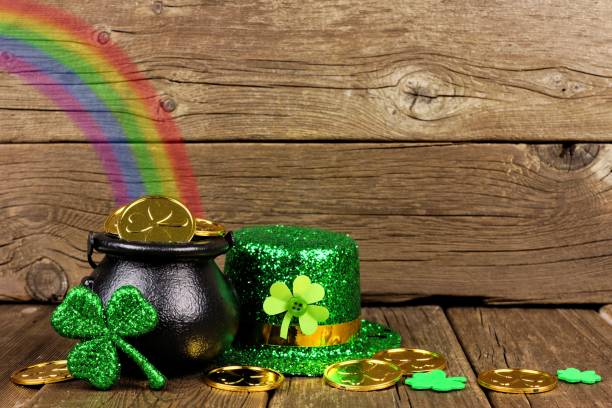 St Patricks Day Pot of Gold with rainbow & decor against wood St Patricks Day Pot of Gold with rainbow, shamrocks and hat against rustic wood afternoon picture stock pictures, royalty-free photos & images