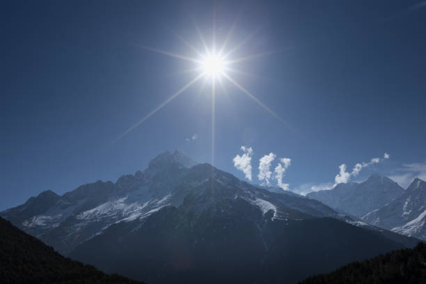 istock sun shining in deep blue sky over mountain range near Mount Everest, Nepal 910711268