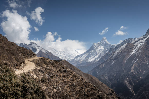 istock Winding trail in the sun, with Mount Everest in background, Nepal 910714580