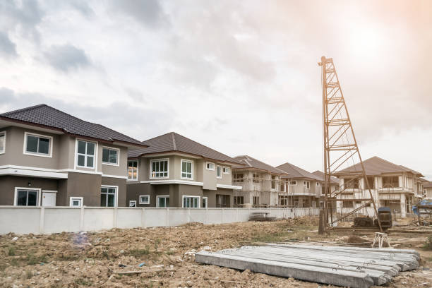 istock house building at construction site with pile driver and concrete piles 910715170