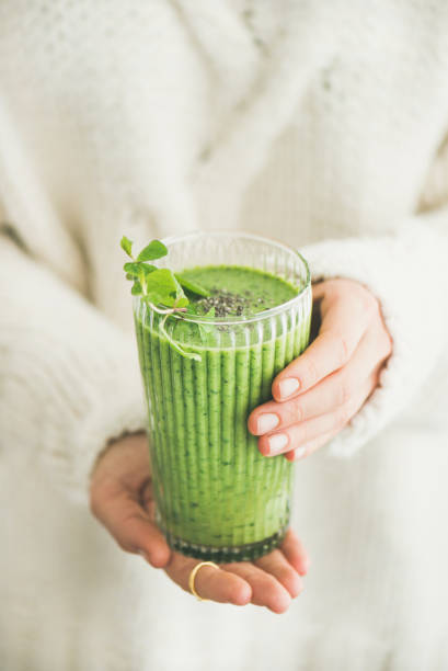 istock Matcha green smoothie with chia seeds in womans hands 910719462