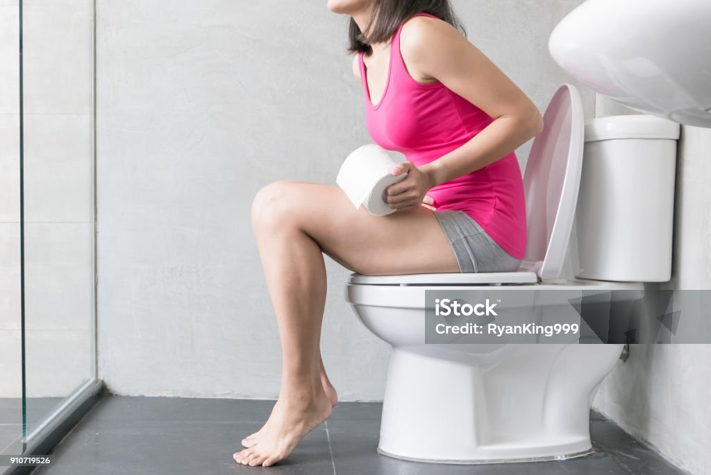 woman feel pain with constipation woman feel pain with constipation in wc Constipation Stock Photo