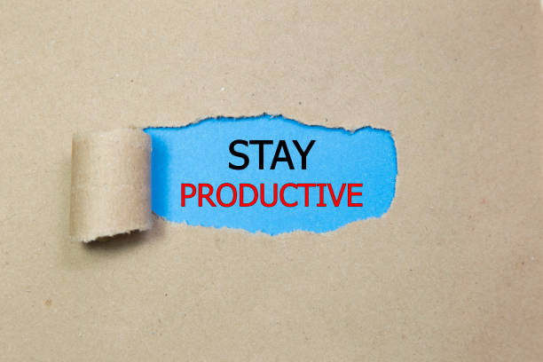 istock Stay Productive Motivation quote written behind a torn paper 910721866