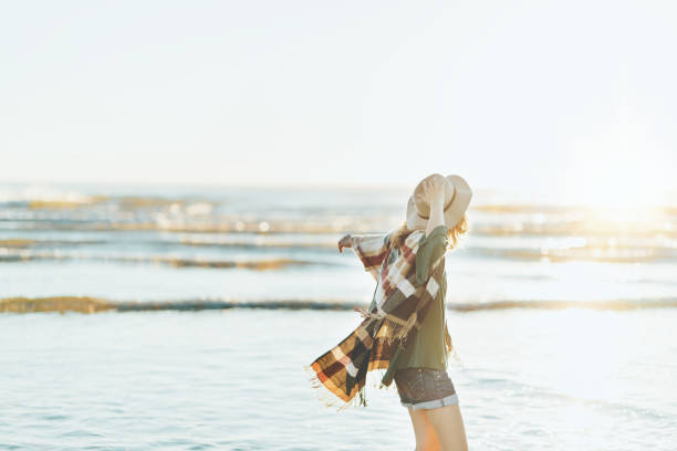 istock Boho style woman with hat having fun near the ocean 910722260