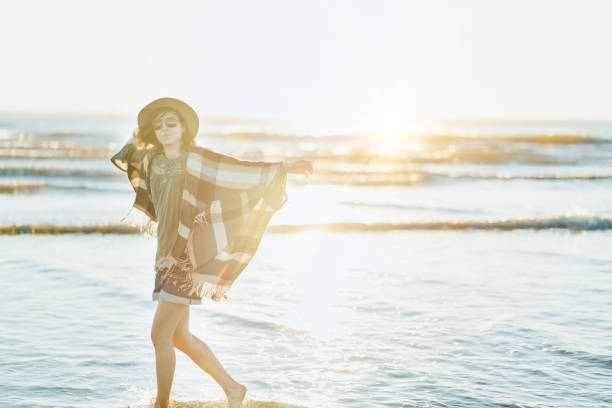 istock Charming woman having fun on the beach 910722262