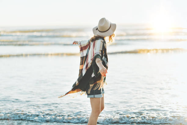 istock Boho style woman having fun on the beach 910722264