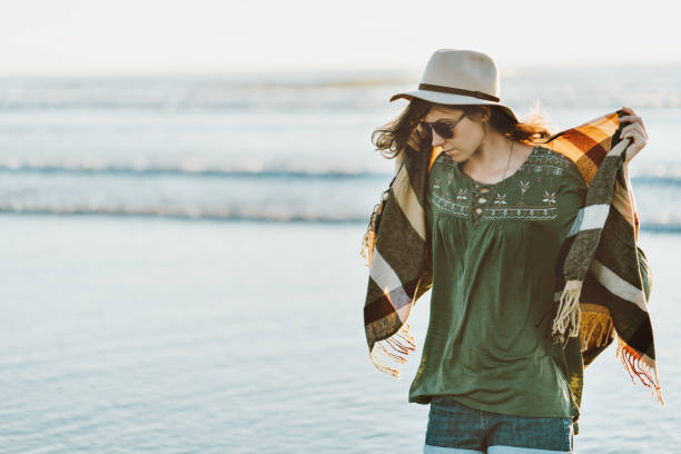 istock Boho style woman with hat having fun near the ocean 910722556