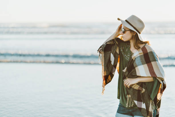 istock Boho style woman with hat having fun near the ocean 910722562