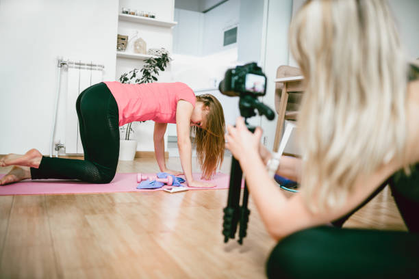 istock Two Females are Making Vlog About Stretching Before Exercising at Home 910722966