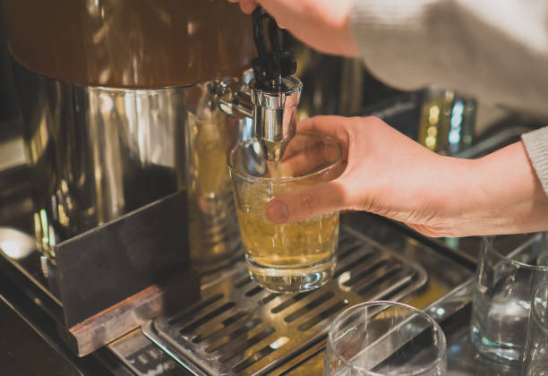 istock Woman pours a drink in the diner with self-service. 910726420