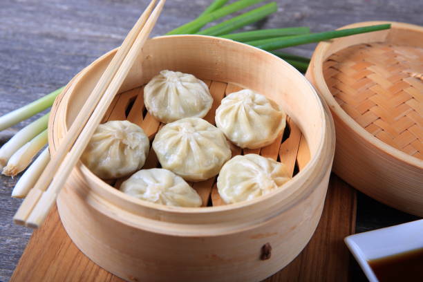 istock Dumplings in a bamboo steamer 910730490