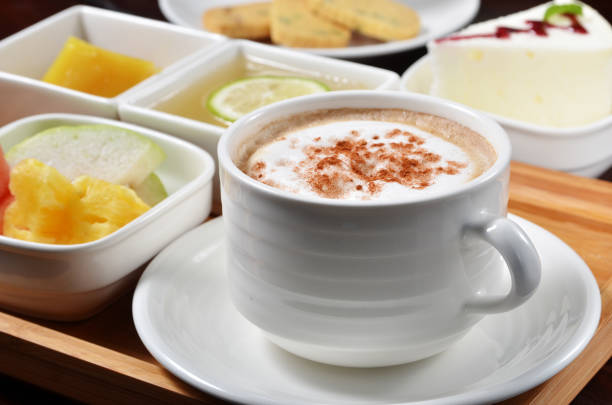 Cup of coffee with dessert, fruit on the table