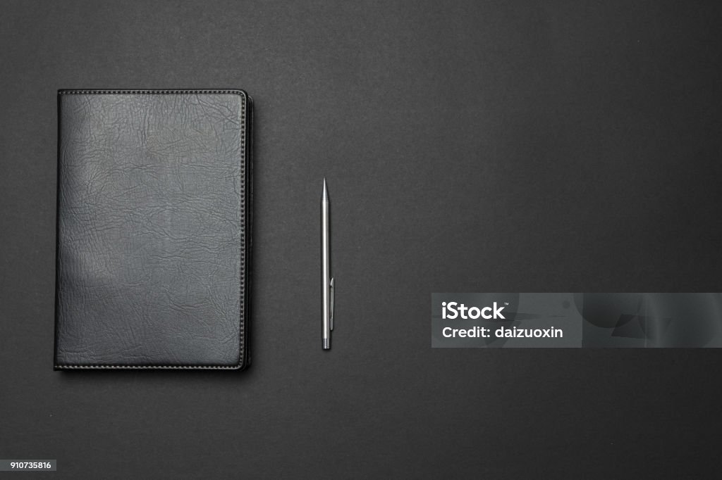 Notebook and pen on the desk Leather Stock Photo