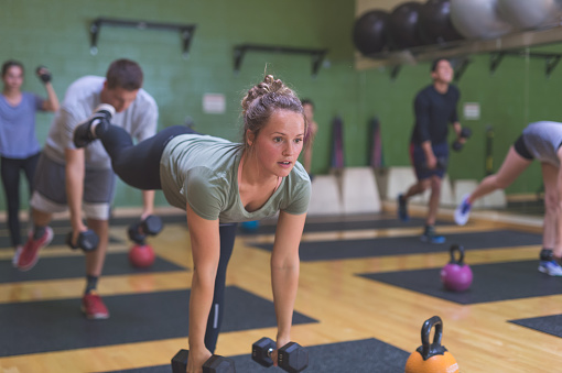 Coed Group Of Collegeage Students Exercise Together At A Modern Fitness ...