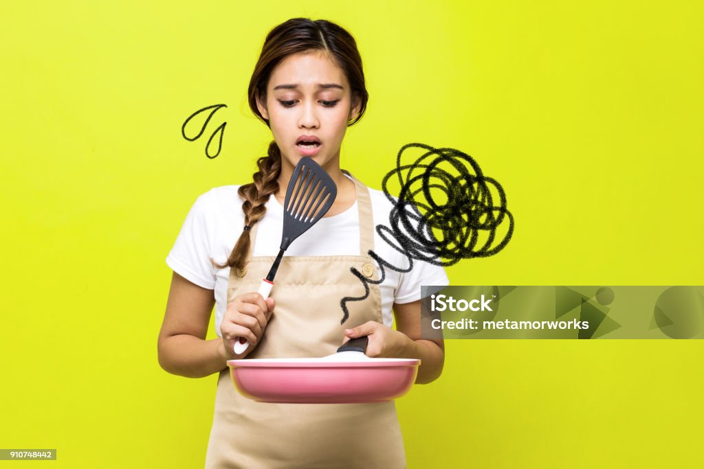 Young woman who failed cooking. Cooking Stock Photo