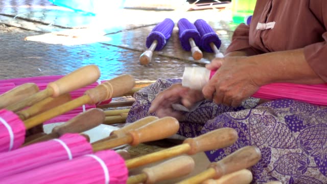 Female working handmade umbrella.