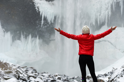Woman visiting a stunning waterfall