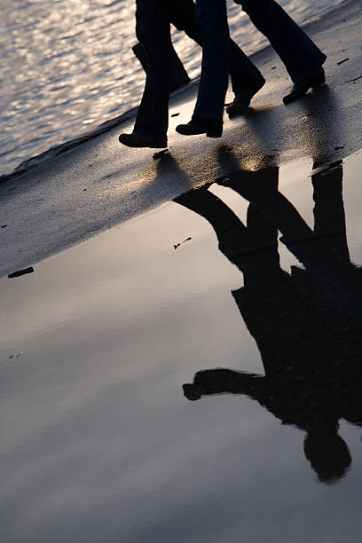 istock walking couple with their reflection in a puddle 91076317