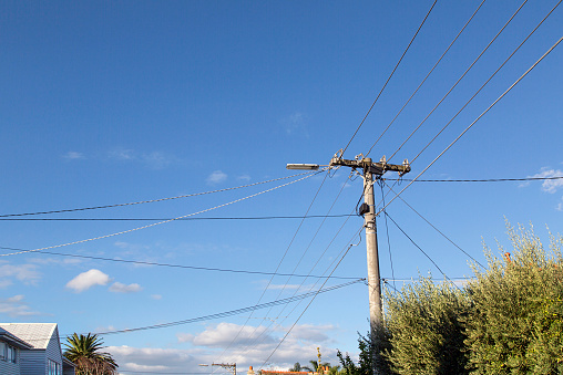 Telegraph Pole with Cable Lines in a Melbourne suburb with a blue sky background.