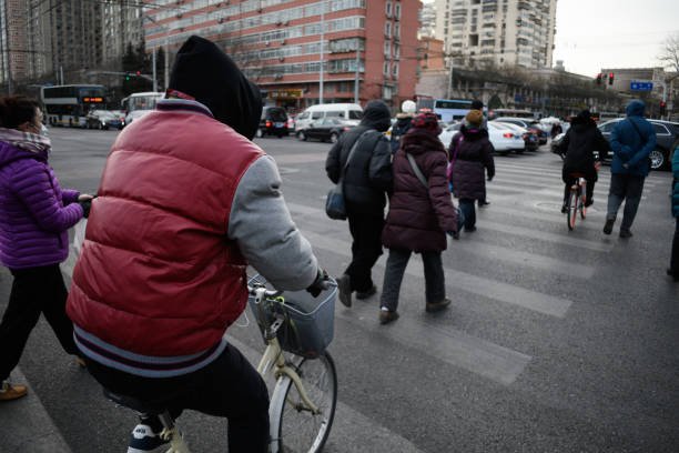 Winter, the morning of Beijing, the crossing of the zebra line, walkers and cyclists, dangerous behavior.