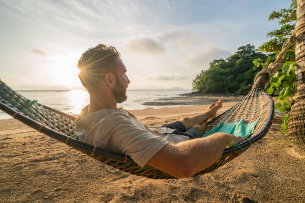 istock Beach holidays concept, man on hammock 910779388