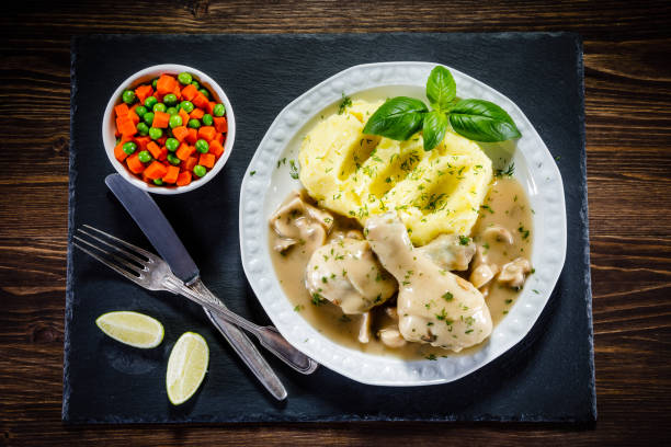 istock Roast chicken leg with boiled potatoes and vegetable salad 910786458